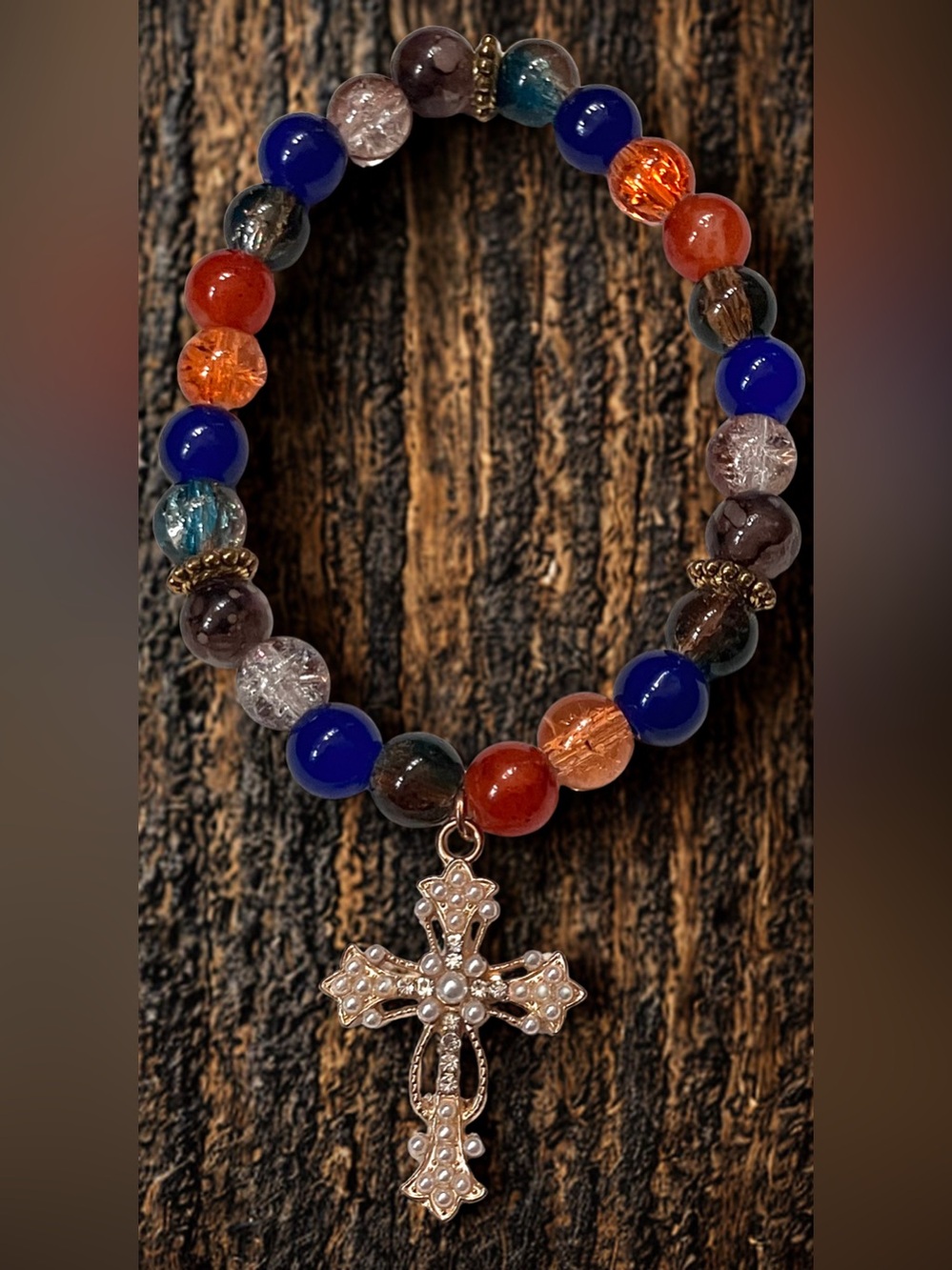 Gold cross charm/ blues, orange, brown glass beaded bracelet handmade